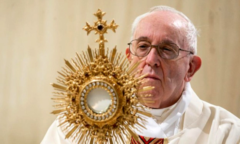 Pope Francis carries the wafer god called the Eucharist.