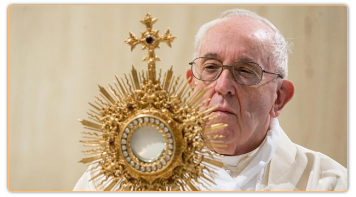 Francis carries the wafer god called the Eucharist in the center of an ornate sunburst display called a Monstrance.