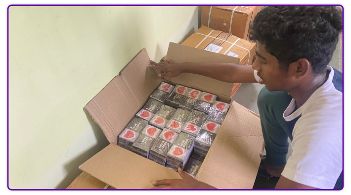 A member of Lordson's church opens a box of 'A Love Story' tracts.