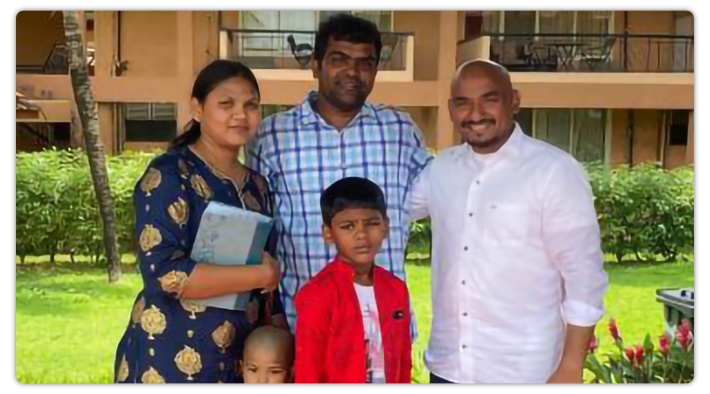 Pastor Lordson Roch stands with family who recently accepted Christ.